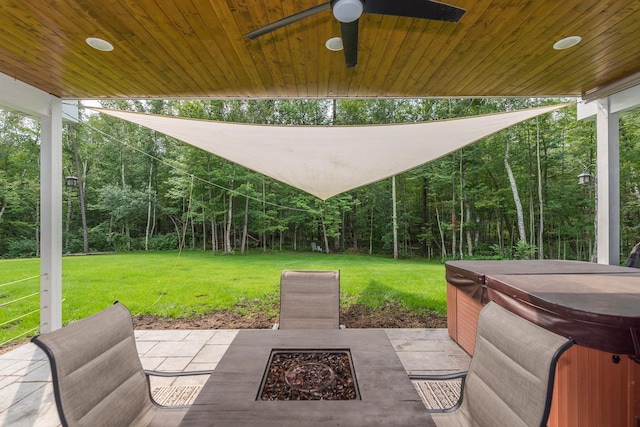 view of patio / terrace featuring ceiling fan, an outdoor fire pit, and a hot tub