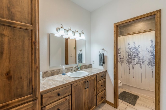 bathroom with toilet, vanity, tile patterned floors, and walk in shower