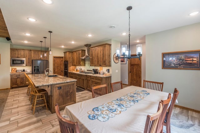 dining area with sink and a chandelier