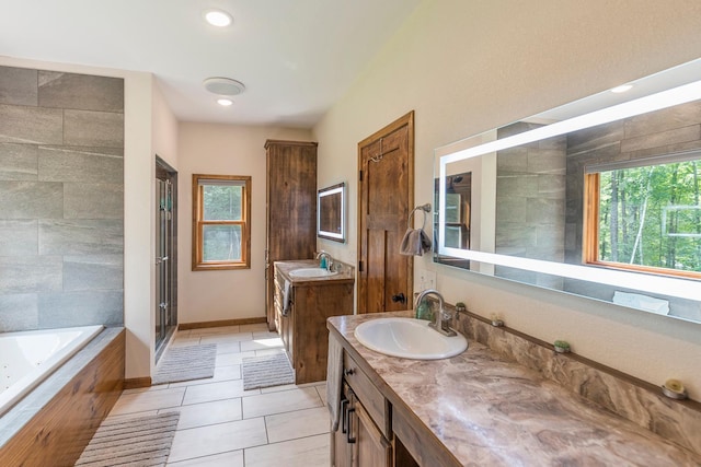 bathroom with vanity, tile patterned floors, and shower with separate bathtub