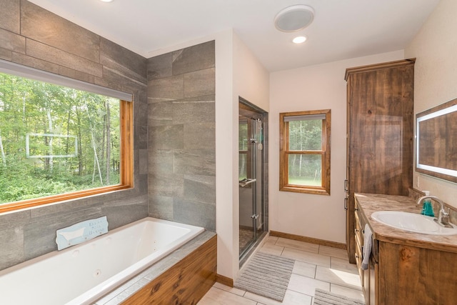 bathroom featuring vanity, tile patterned floors, and plus walk in shower