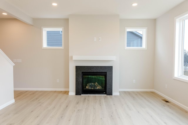 unfurnished living room featuring light hardwood / wood-style flooring