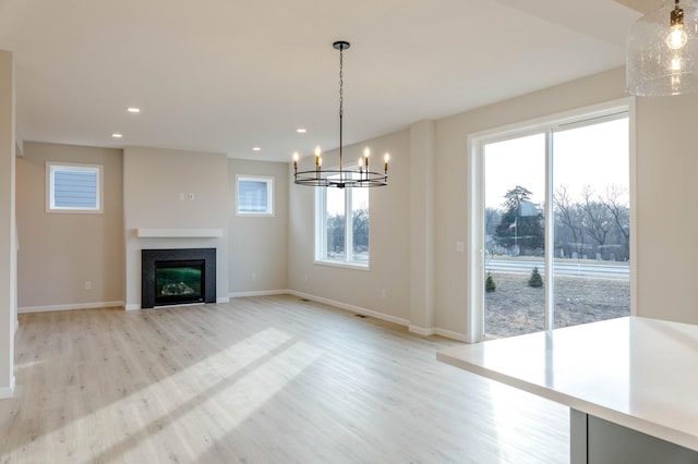 interior space with light hardwood / wood-style flooring and an inviting chandelier