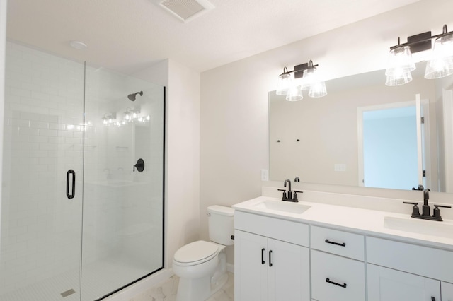 bathroom with vanity, toilet, and a shower with shower door