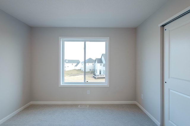 empty room featuring light colored carpet