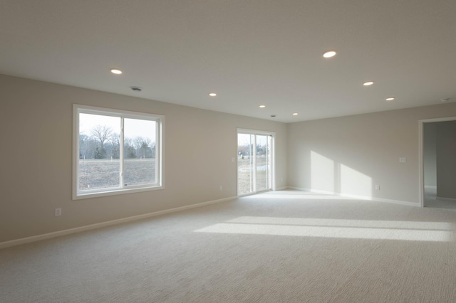 unfurnished room with light colored carpet