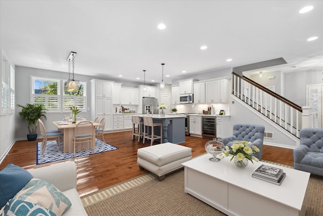 living room featuring wine cooler and dark hardwood / wood-style floors