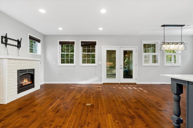 unfurnished living room featuring a fireplace and dark hardwood / wood-style floors