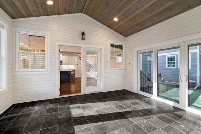 unfurnished sunroom with wood ceiling, lofted ceiling, and a healthy amount of sunlight