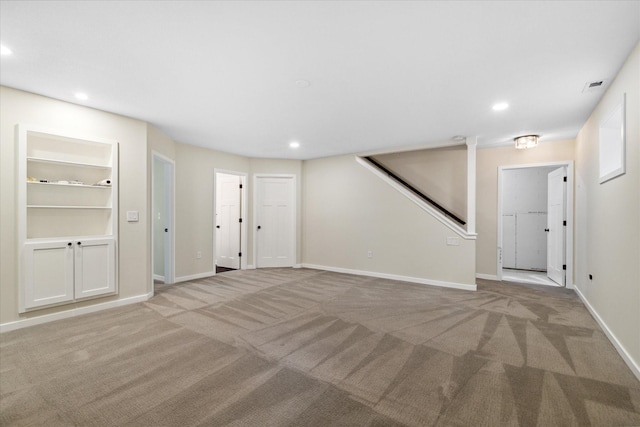 interior space featuring built in features and light carpet