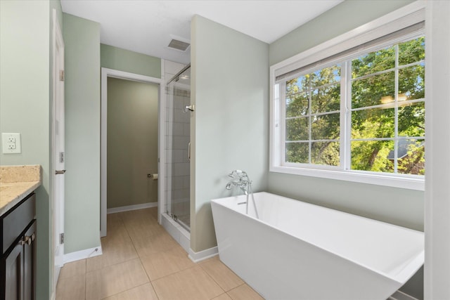 bathroom with vanity, tile patterned floors, and plus walk in shower