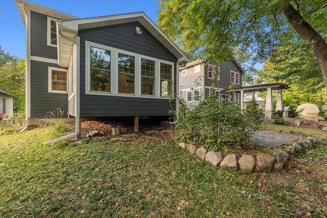 exterior space with a patio area and a lawn