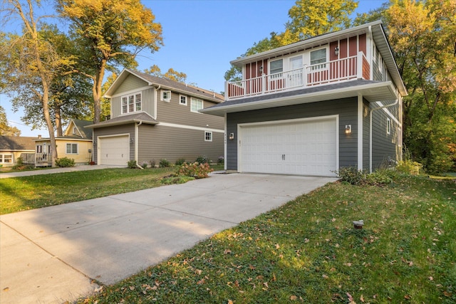 view of property with a garage and a front lawn