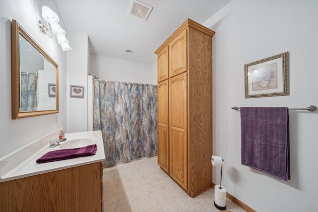 bathroom featuring vanity and walk in shower