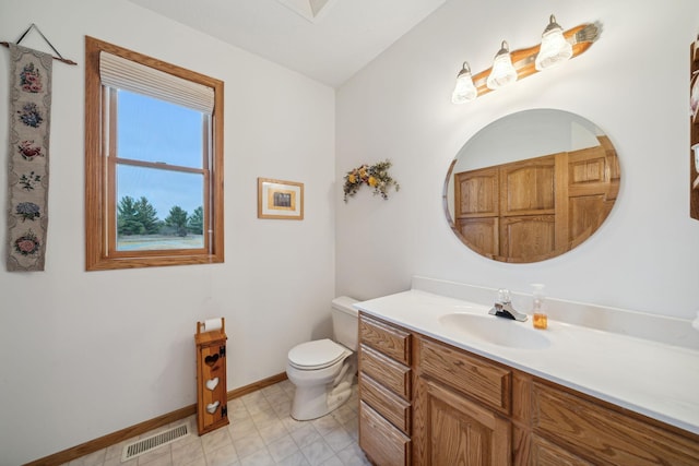 bathroom with toilet and vanity