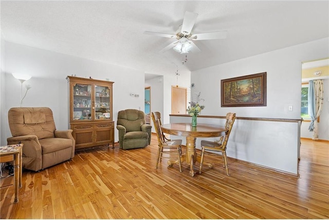 dining room with a textured ceiling, ceiling fan, and light wood-type flooring