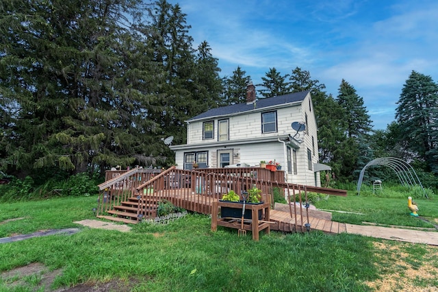 view of front of house featuring a deck and a front lawn