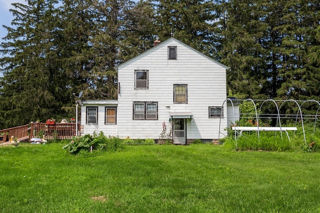 rear view of property with a lawn