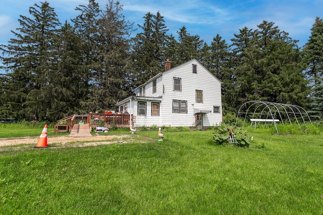 view of home's exterior with a yard and a deck