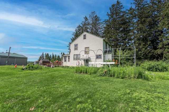 rear view of house featuring a lawn