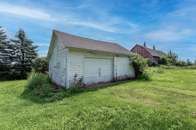 garage featuring a lawn