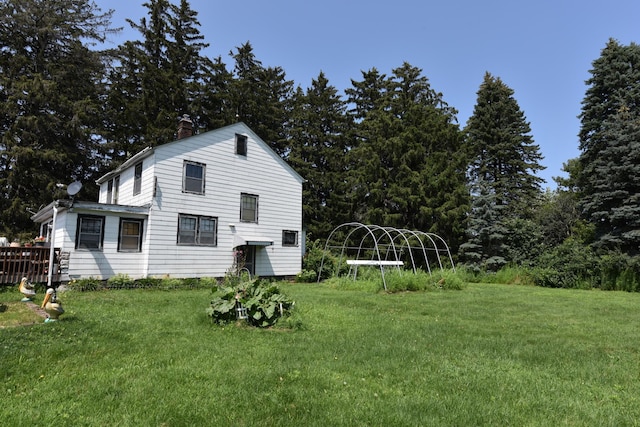 view of side of property with a lawn