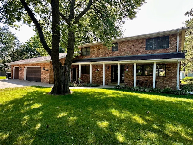 view of front of home with a garage and a front lawn