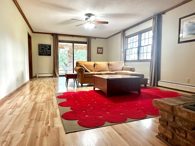 living area featuring a textured ceiling, a baseboard radiator, a ceiling fan, light wood-style floors, and ornamental molding