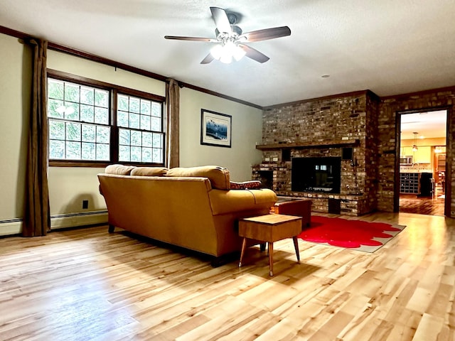 living room featuring light wood-type flooring, a brick fireplace, ceiling fan, and a baseboard heating unit