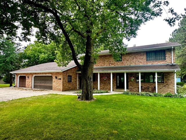 view of front of home featuring a garage and a front lawn