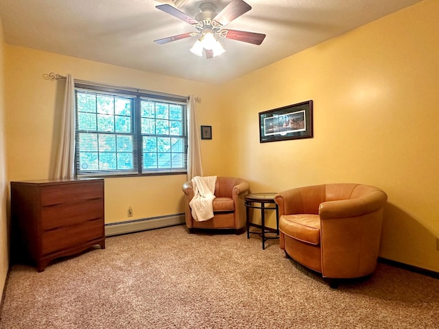 living area with light carpet, ceiling fan, a baseboard heating unit, and baseboards