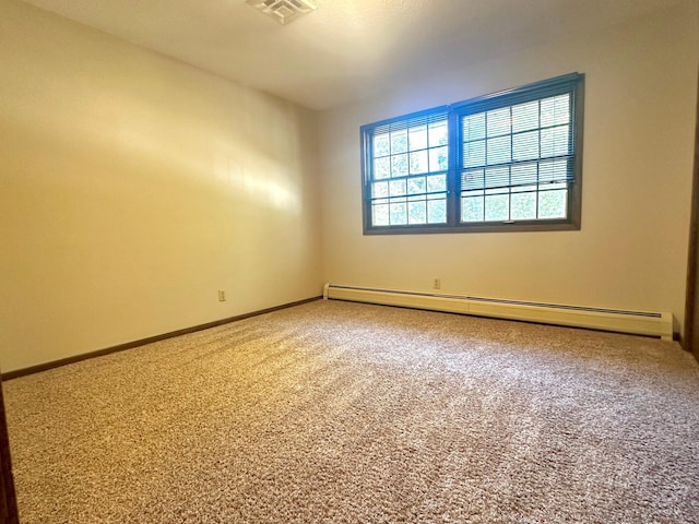 unfurnished room with baseboards, carpet flooring, visible vents, and baseboard heating