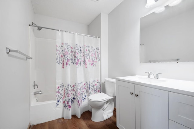 full bathroom featuring vanity, hardwood / wood-style flooring, shower / bath combination with curtain, and toilet