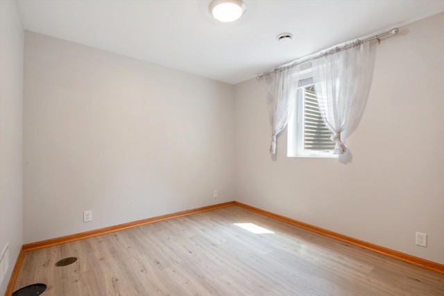 spare room featuring light wood-type flooring