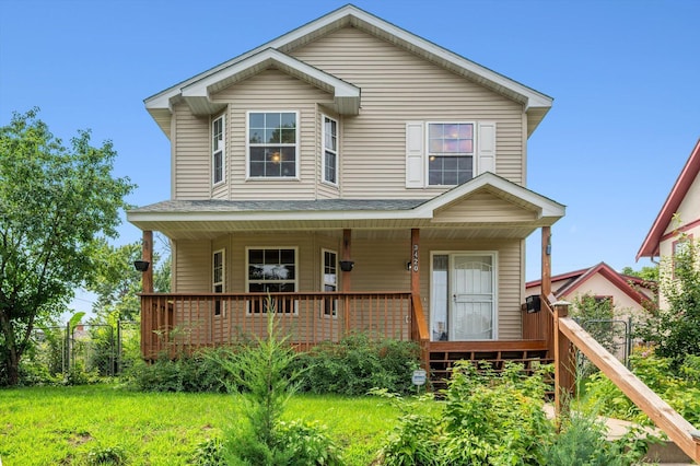 view of front of house with covered porch and a front yard