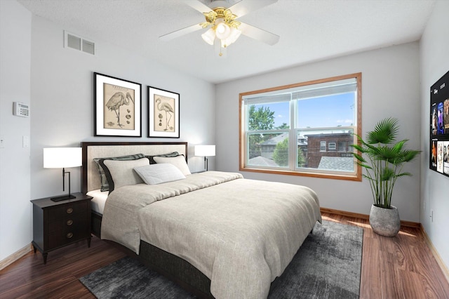 bedroom featuring dark hardwood / wood-style floors and ceiling fan