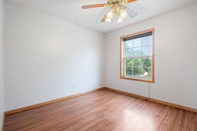 spare room featuring hardwood / wood-style floors and ceiling fan