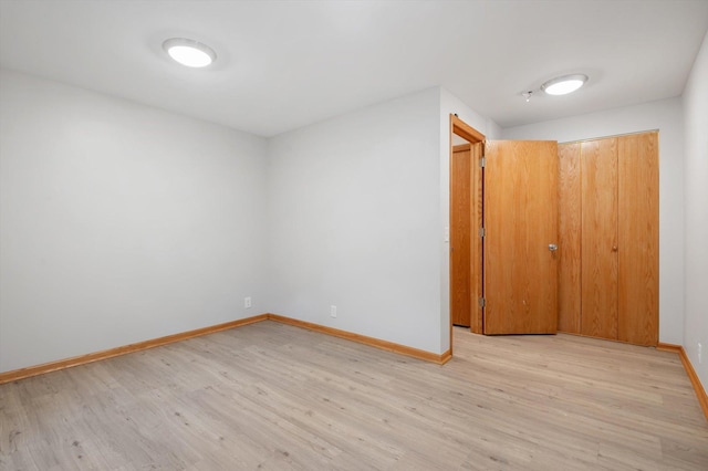 unfurnished room with light hardwood / wood-style flooring