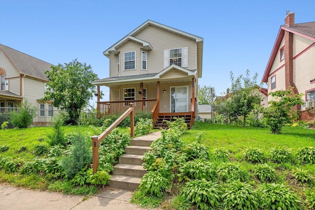 view of front of home with covered porch and a front yard