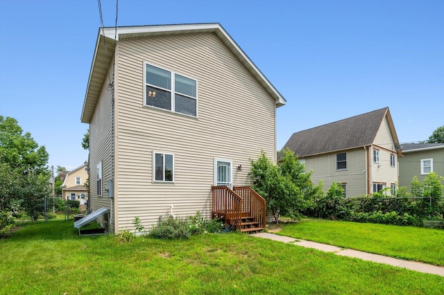 back of house featuring a yard