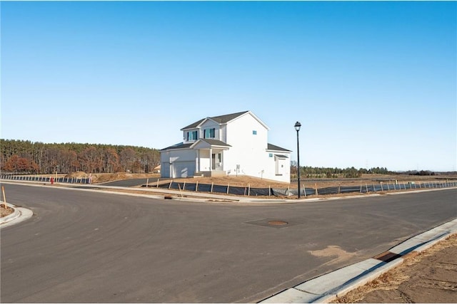 view of street with street lighting and curbs