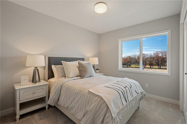 carpeted bedroom featuring baseboards