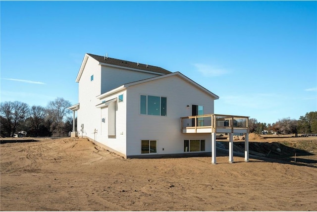 rear view of property with a wooden deck