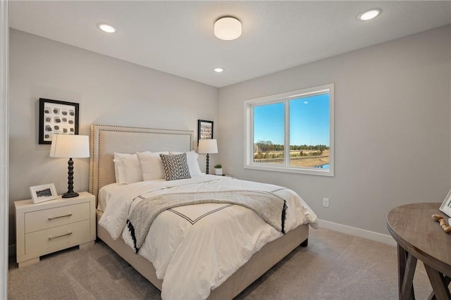 bedroom featuring light carpet, recessed lighting, and baseboards