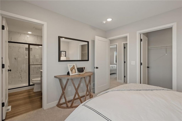 bedroom featuring carpet, recessed lighting, a closet, ensuite bath, and baseboards