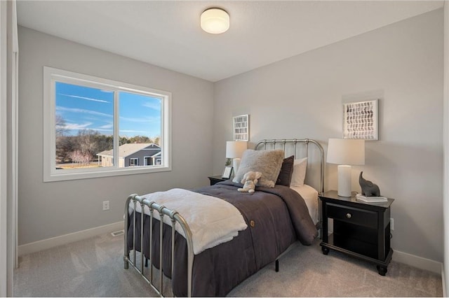 bedroom featuring carpet floors and baseboards