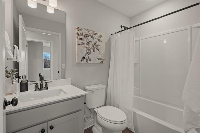 bathroom with shower / bath combination with curtain, vanity, and toilet