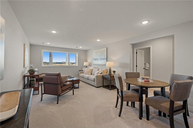 living room with recessed lighting and light colored carpet