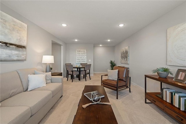 living area featuring light carpet, baseboards, and recessed lighting