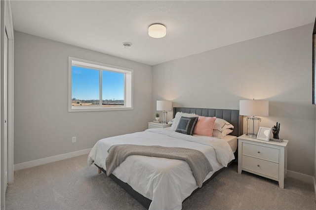 carpeted bedroom with baseboards